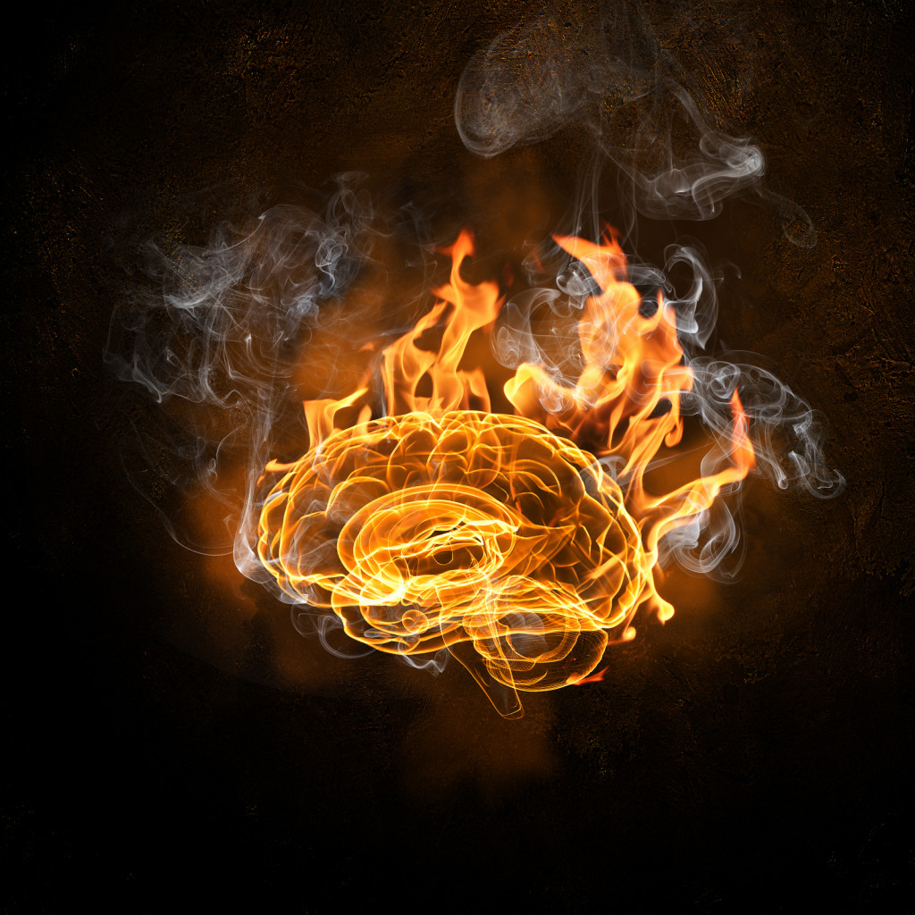 Human brain in fire flames against black background